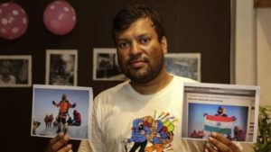 Satyarup Sidhantha holds the genuine photo in his right hand and the "doctored" photo in his left hand [AP]