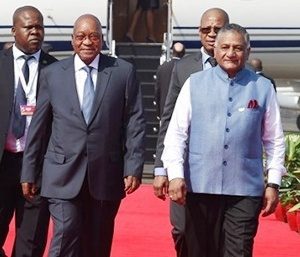 South African President, Jacob Zuma(C) is accompanied by Indian Minister of State for External Affairs, General VK Singh (R) upon his arrival at the airport in Goa on October 15, 2016. Prime Minister Narendra Modi will look to reinvigorate the BRICS group of emerging nations at a summit this weekend with India seen as a bright spot in a bloc whose clout has been undermined by economic woes. / AFP PHOTO / MONEY SHARMA